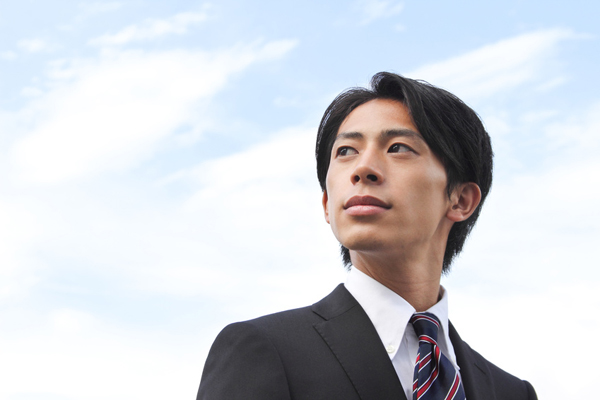 A businessman looking up at the sky